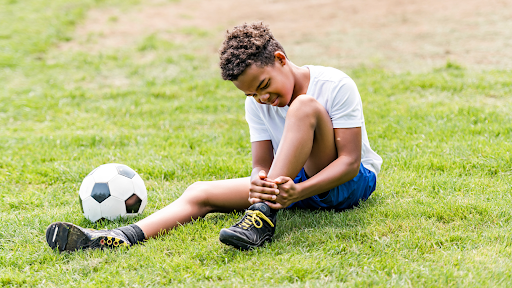 Young athlete with soccer injury needing doctor evaluation